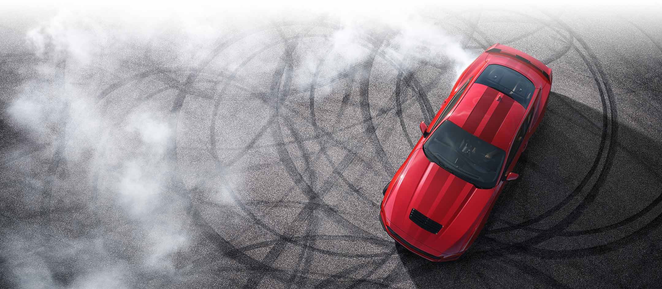 Overhead view of a 2024 Ford Mustang® model with tire tracks on pavement | Christie Motors in Langdon ND